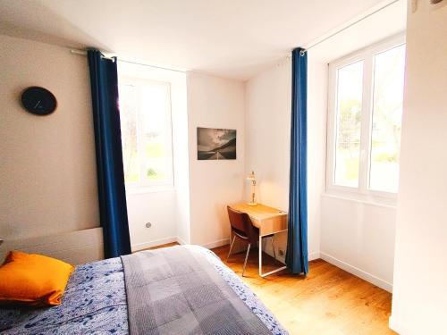 a bedroom with a bed and a desk and a window at Beau studio indépendant in Arraute-Charritte