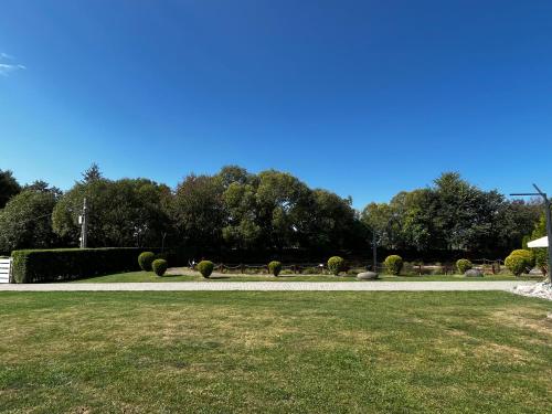 a walkway in a park with grass and trees at Szépasszony Guest House in Vlăhiţa