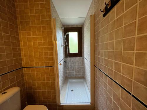 a small bathroom with a shower and a toilet at Can Geneta in Molló