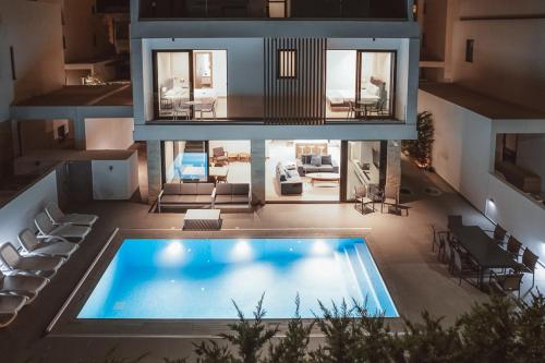 an aerial view of a house with a swimming pool at Periyiali Konnos Villas Beach Resort in Protaras