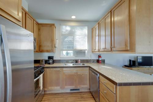 a kitchen with wooden cabinets and a stainless steel refrigerator at Charming Oak View Retreat about 5 Mi to Ojai Valley! in Oak View