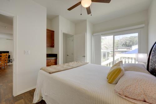 a bedroom with a white bed with a ceiling fan at Oak View Home with Private Covered Patio! in Oak View