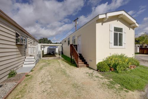 a white building next to a house at Oak View Home with Private Covered Patio! in Oak View
