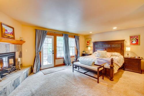 a bedroom with a bed and a fireplace at Forested Cle Elum Home with Trail Access and Deck in Cle Elum