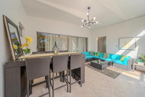 a living room with a table and a blue couch at Fantastic Island House 1 mile to the beach with heated pool in Sarasota