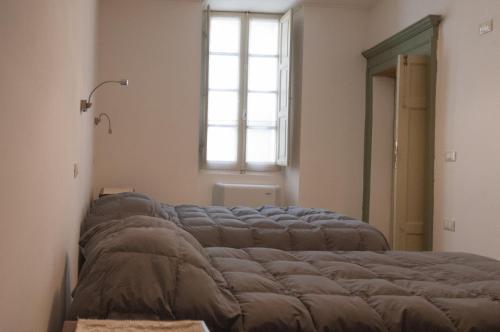 a bed in a room with a window at affittacamere Monte inni in Ozieri