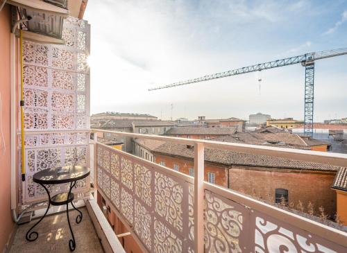 a balcony with a table and a view of a city at CASA EMILIA - * In the HEART of MODENA * in Modena