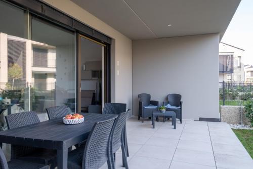 a patio with a black table and chairs at residence borgo secolo in Peschiera del Garda