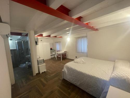 a bedroom with a bed and a room with a bathroom at Casa Borgata in Grondona