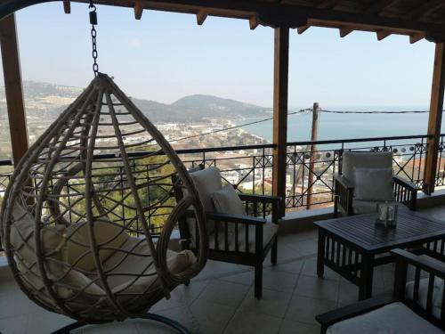 a hanging hammock on a balcony with a view at Kavala Bay View in Kavala
