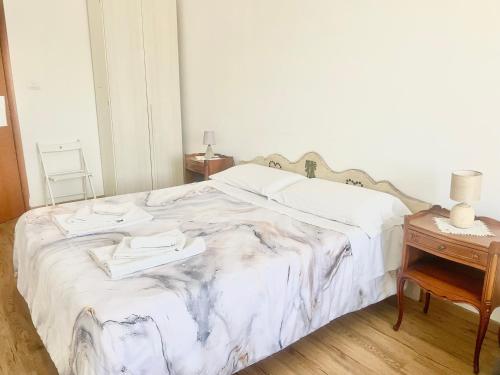 a bedroom with a bed with two towels on it at Cavour16 rent bedrooms in Genova