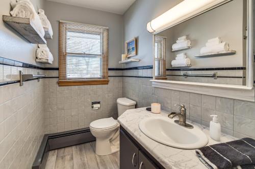 a bathroom with a sink and a toilet and a mirror at Walk to Lake Beach Glenwood Vacation Rental! in Glenwood