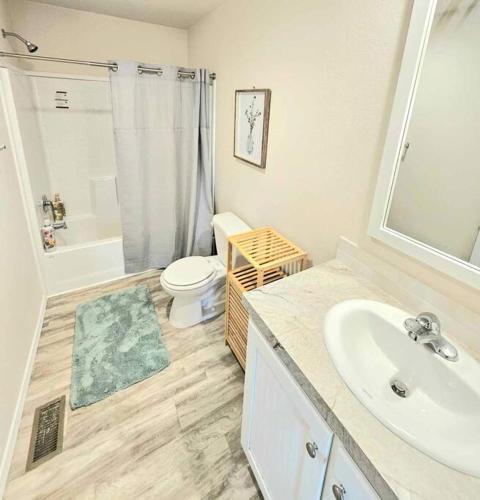 a bathroom with a sink and a toilet and a shower at New house ready for you in Garden City
