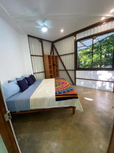 a bedroom with a large bed in a room at Peaceful Jungle Villa Cooper - Pool & Parking for 2 persons in Puerto Viejo