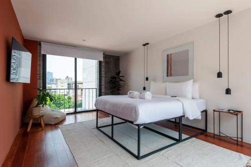1 dormitorio con cama grande y ventana grande en Fancy and Modern 2BR Duplex in Roma Norte, en Ciudad de México