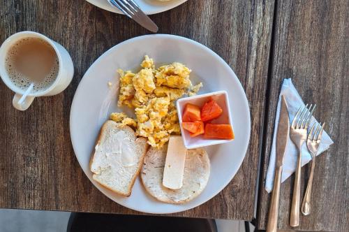 a plate of breakfast food with toast and a cup of coffee at Hotel 47 Medellin Center in Medellín