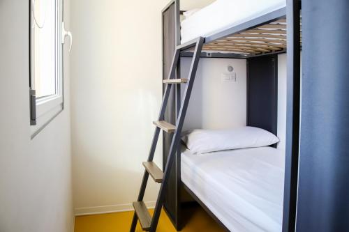 a couple of bunk beds in a room at Nomad Hostel in Treviso
