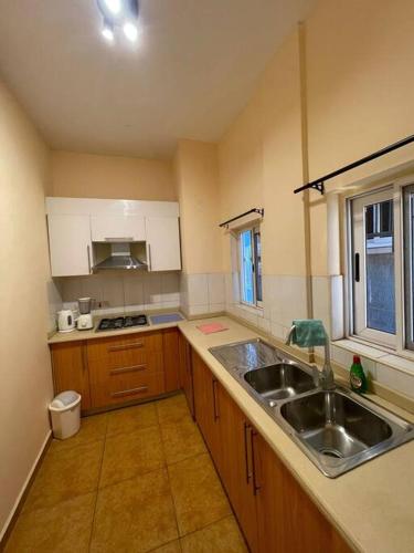 a kitchen with a sink and a counter top at 2 bedrooms Apartment Devtraco Tema 25 in Tema