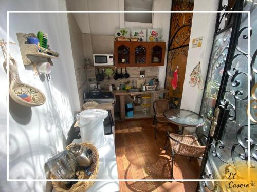a view of a kitchen with a table and chairs at Minidepa hermosa vista - H. El Casero in Cajamarca