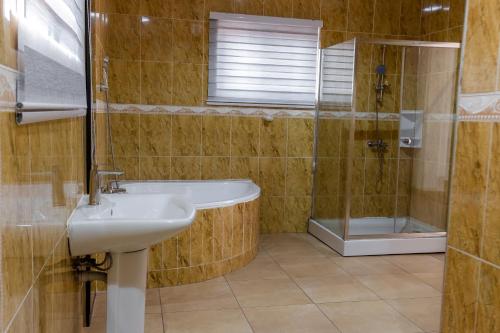 a bathroom with a sink and a shower at Shalom Villas in Mamobi