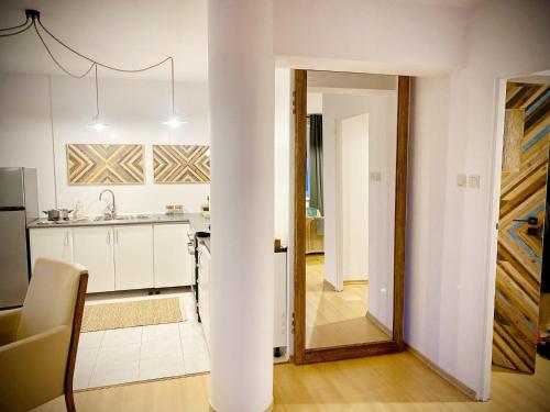 a kitchen with a column in the middle of a room at Mozaika Art Apartment PL LT EN in Suwałki