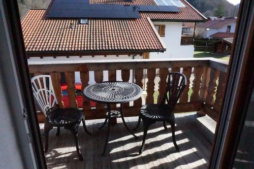 a patio with a table and chairs on a balcony at Haus Alpenblick in Ruhpolding