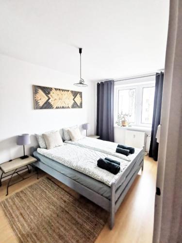 a bedroom with a bed and a rug at Mozaika Art Apartment PL LT EN in Suwałki