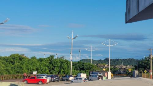 un aparcamiento con coches aparcados y turbinas eólicas en Bela Vista - Hospedagem, en Navegantes