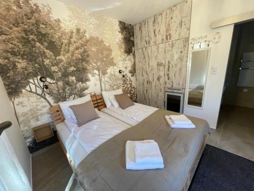 a bedroom with a large bed in a room at Vitality Apartman in Makó