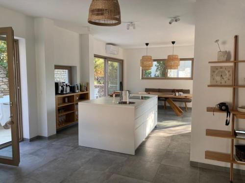a kitchen with a white island in a room at Villa Marumare in Milna