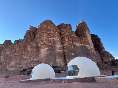 two domed tents in front of a mountain at Bacific camp in Wadi Rum