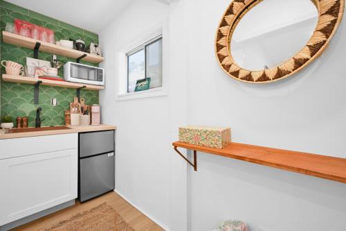 a kitchen with a mirror and a counter at Chic Modern Designed Home with Private Studio in Newport Beach