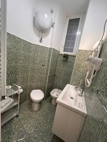 a bathroom with a sink and a toilet and a shower at Step by Rome apt in Rome