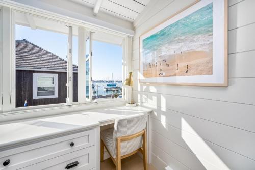 a home office with a desk and a window at Balboa Island Luxury Penthouse Suite With Bay Views in Newport Beach