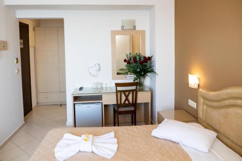 a hotel room with a bed and a desk at Kronos Hotel in Heraklio Town