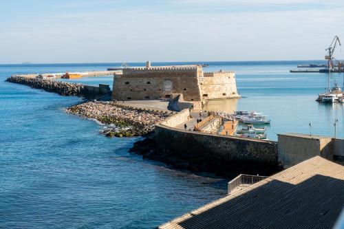 an old building in the middle of the water at Kronos Hotel in Heraklio Town
