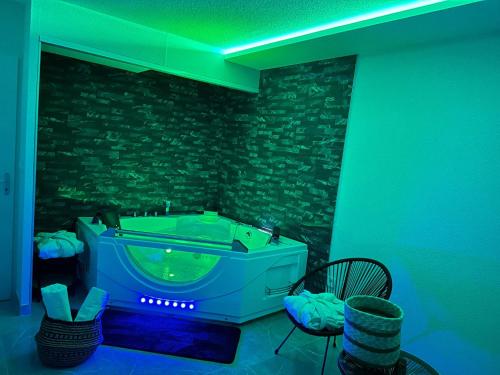 a jacuzzi tub in a room with a stone wall at T3 5 étoile jacuzzi in Toulouse