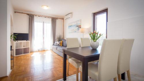 a living room with a table and a couch at Apartments Luce in Rovinj