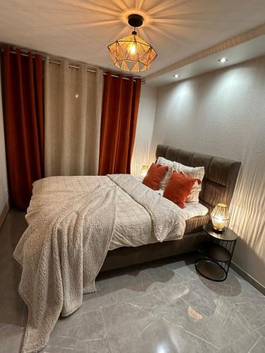 a bedroom with a large bed with red curtains at T3 5 étoile jacuzzi in Toulouse
