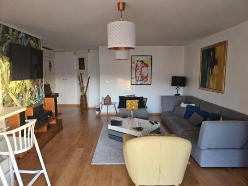 a living room with a couch and a table at La BellaGeal - Charme & Confort in Schœlcher