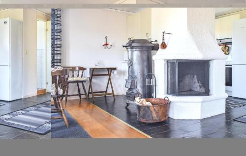 two pictures of a living room with a fireplace at Stunning Apartment In Vetlanda in Vetlanda