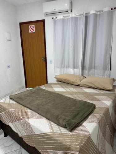 מיטה או מיטות בחדר ב-Pousada do Rm