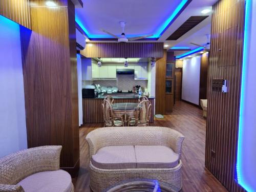 a room with a table and chairs and a kitchen at Entire 1 BED ROOM Studio Apartment Uttara 14 in Dhaka