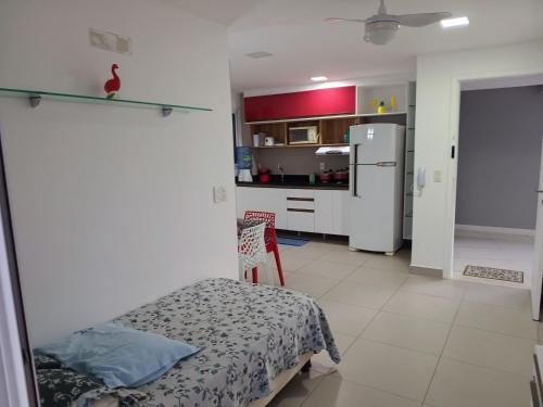 a kitchen with a bed and a white refrigerator at Apartamento 2 quartos May Way Meireles uma quadra da Beira-mar in Fortaleza