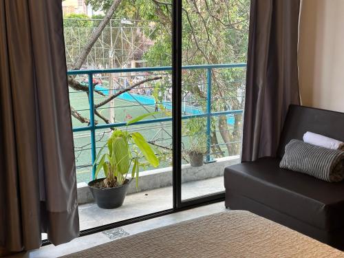 a room with a window with a view of a pool at Hotel Casa Lucca in Medellín
