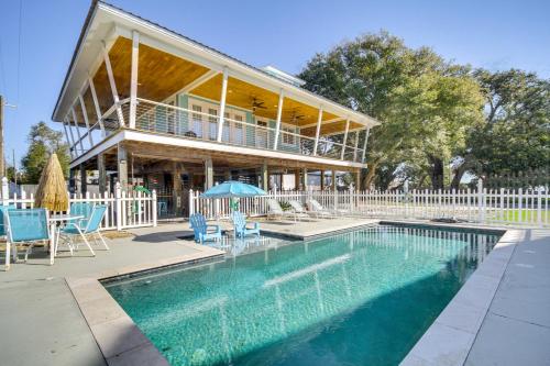 a house with a swimming pool in front of a house at Walk to Beach Stunning Gulfport Getaway in Gulfport