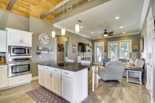 a kitchen with white cabinets and a counter top at Walk to Beach Stunning Gulfport Getaway in Gulfport