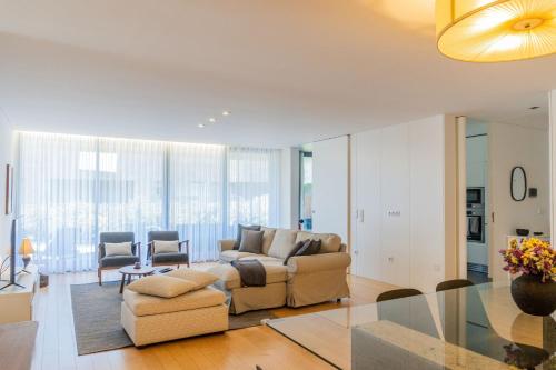 a living room with a couch and a table at Beach & Garden Apartment in Ponta Delgada