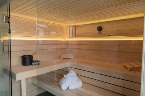 a sauna with two towels sitting on a shelf at Wellness House Oase Spa mit Whirlpool in Timmendorfer Strand