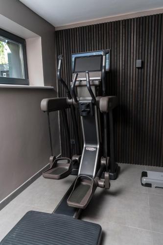 a gym with two tread machines in a room at Wellness House Oase Spa mit Whirlpool in Timmendorfer Strand